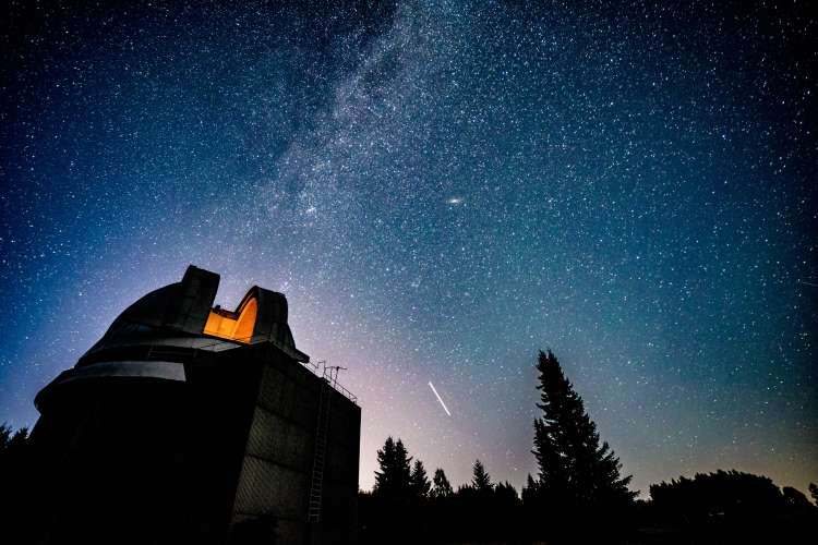 Milky Way galaxy over observatory Adobe image